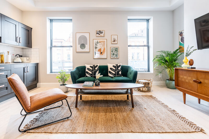 EirStay serviced apartment Camden Street Dublin 2 stylish living room with green sofa for corporate short stays