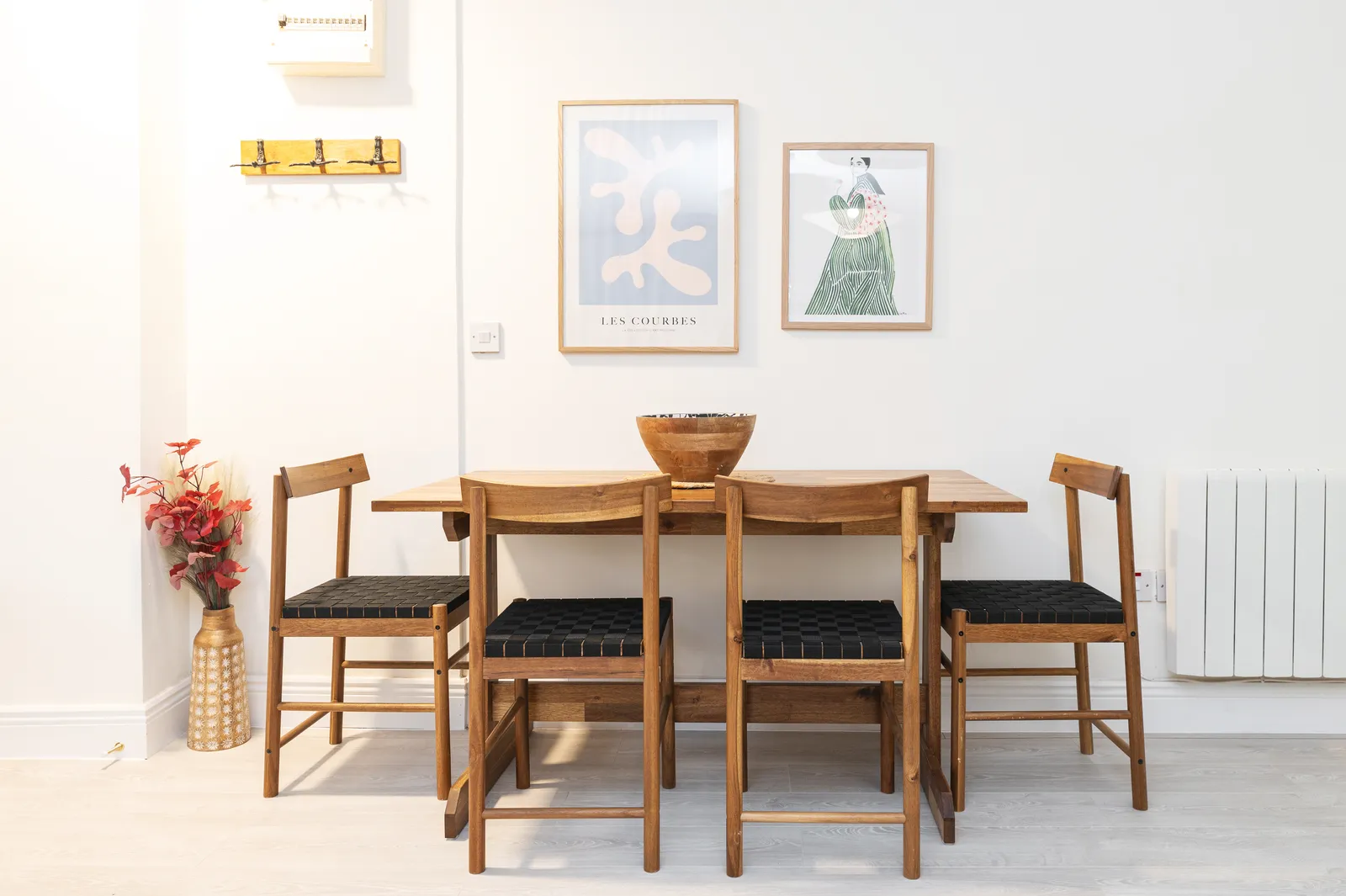 Dining area with timber table and woven chairs at Cromwell's Fort, Wexford