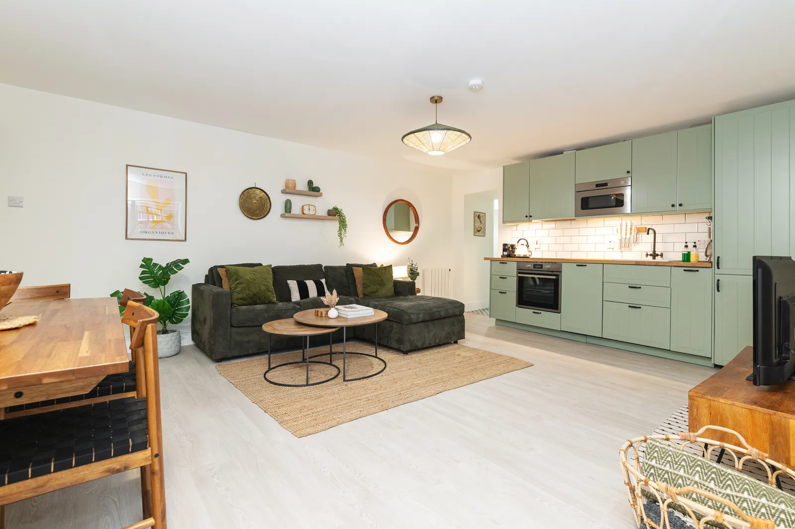 New open-plan living space with sage green kitchen at Cromwell's Fort, Wexford