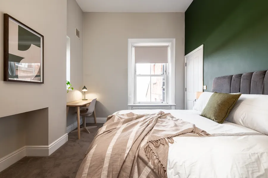 Staged bedroom with deep green feature wall at Morehampton Road, Donnybrook, Dublin