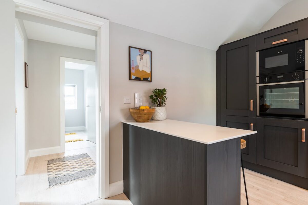 Kitchen island with built-in Neff oven and fruit bowl in EirStay corporate short stay apartment Camden Street Dublin 2