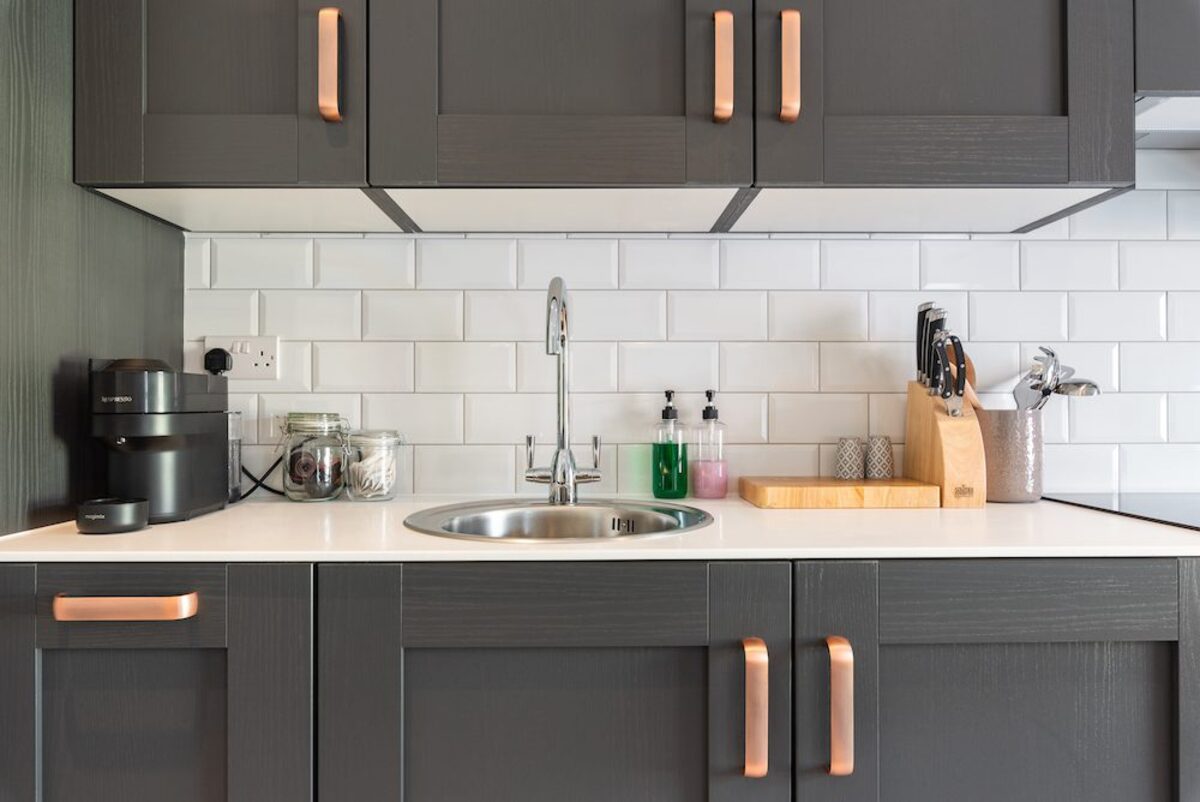 Kitchen countertop with Nespresso machine knife block and copper handle detail in EirStay serviced apartment Camden Street Dublin 2