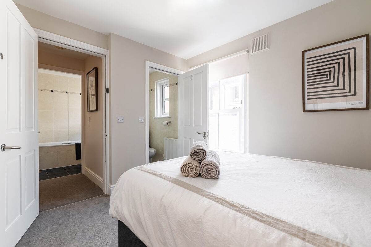 Bedroom with ensuite bathroom and fresh towels in EirStay corporate short stay serviced apartment Donnybrook Dublin