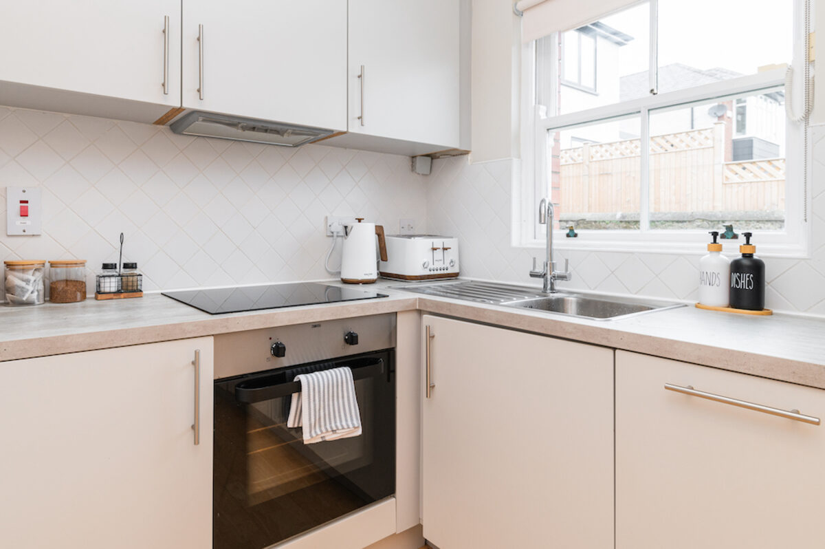 Equipped kitchen with oven hob and herringbone splashback in EirStay corporate accommodation Donnybrook Dublin 4
