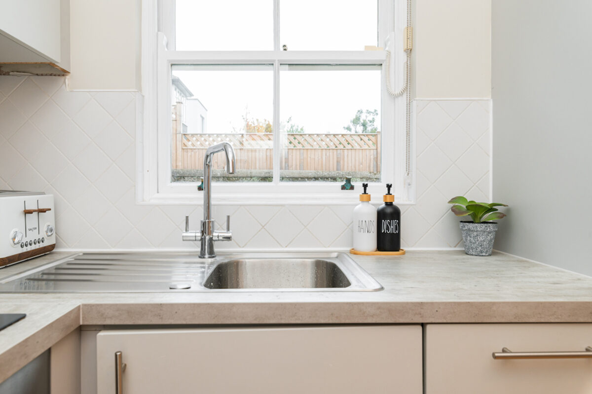 Kitchen sink and countertop with garden view in EirStay corporate short stay apartment Morehampton Road Dublin 4
