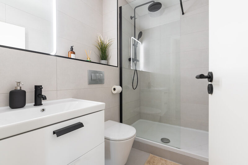 Modern walk-in shower room with rainfall head and vanity unit in EirStay Islandbridge serviced apartment Dublin 8