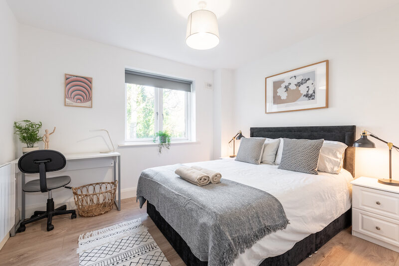 Bedroom with dedicated workspace desk and garden window view in EirStay Islandbridge corporate apartment Dublin 8