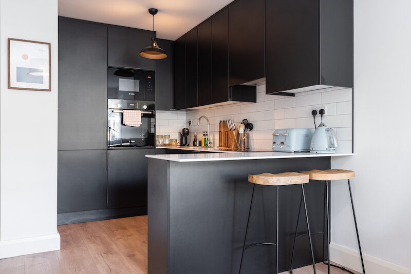 Fully equipped matte-black kitchen with breakfast bar stools in EirStay Islandbridge corporate accommodation Dublin 8