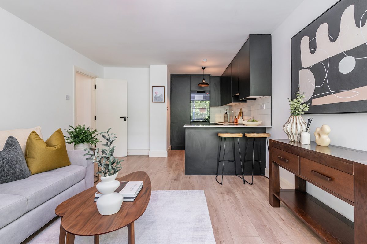 Open-plan living and kitchen with sofa, breakfast bar and console table in EirStay Islandbridge serviced apartment Dublin 8