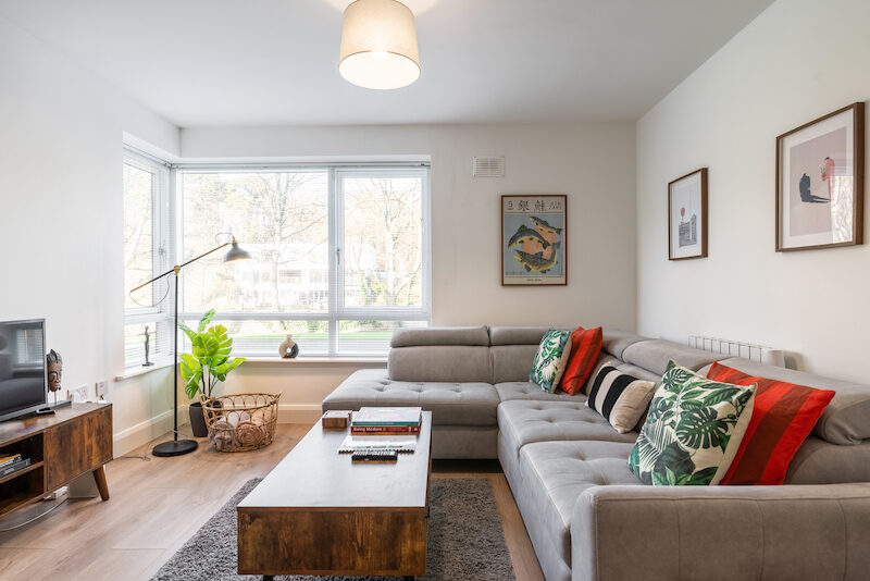 Spacious living room with large windows and garden views in EirStay Islandbridge corporate apartment Dublin 8
