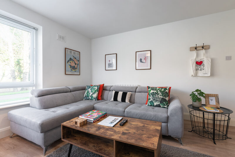 Corner sofa and artwork wall in EirStay Islandbridge serviced apartment Islandbridge Dublin 8 short-term let