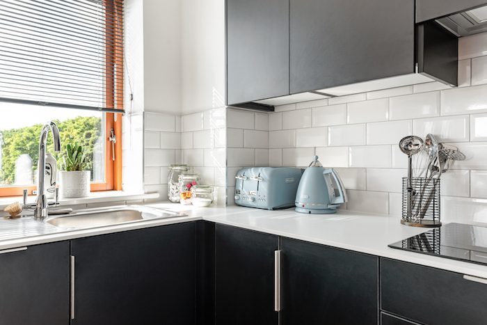 Kitchen corner with blue DeLonghi toaster and kettle sink and metro tile splashback in EirStay corporate short stay Kilmainham Dublin 8