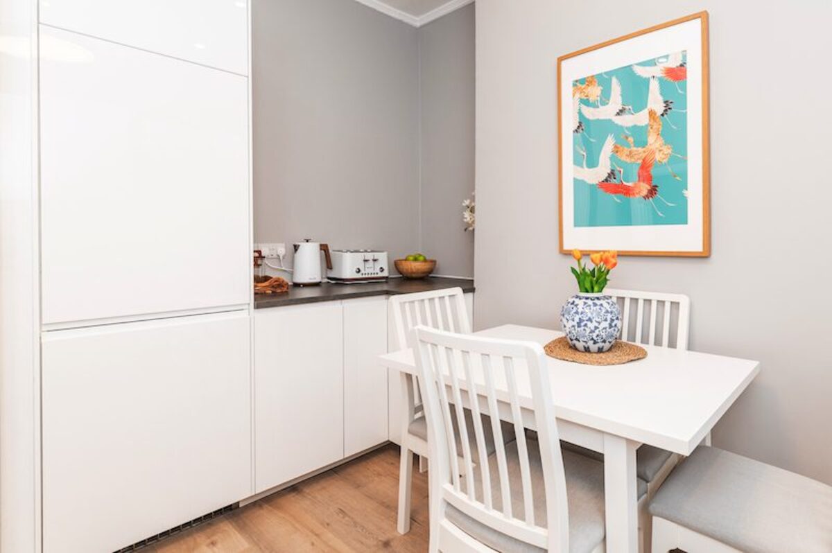 Kitchen dining area with koi art print in EirStay corporate stay apartment Ranelagh Dublin 6