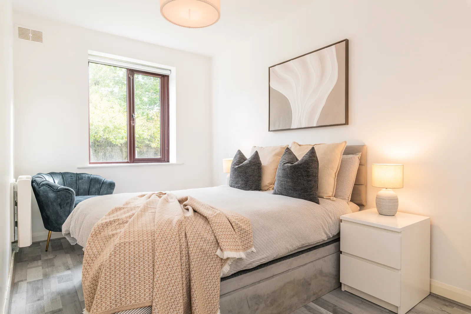 Double bedroom with bedside lamps and a window in the Rathgar apartment