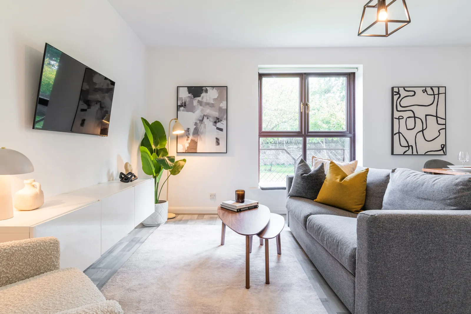 Rathgar apartment living room with grey sofa, coffee table and a large window