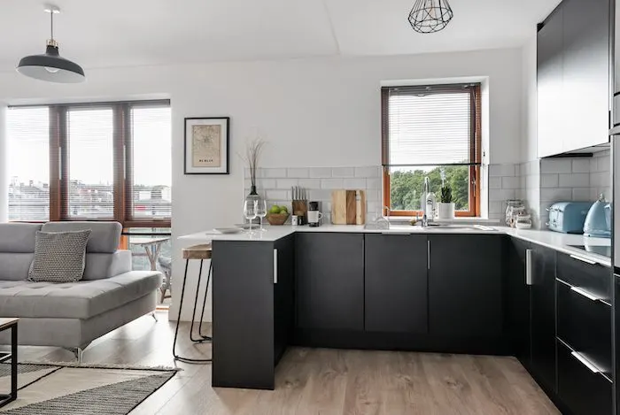 Open plan kitchen and living area with dark grey units metro tile splashback and breakfast bar in EirStay corporate accommodation Kilmainham Dublin 8