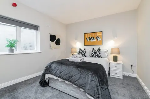 Master bedroom with premium bedding and bedside lamps in EirStay corporate stays apartment Ranelagh Dublin 6