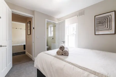 Bedroom with ensuite bathroom and fresh towels in EirStay corporate short stay serviced apartment Donnybrook Dublin