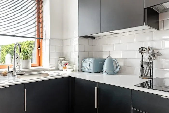 Kitchen corner with blue DeLonghi toaster and kettle sink and metro tile splashback in EirStay corporate short stay Kilmainham Dublin 8