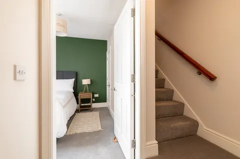 Second bedroom entrance with green accent wall in EirStay corporate short stay apartment Donnybrook Dublin
