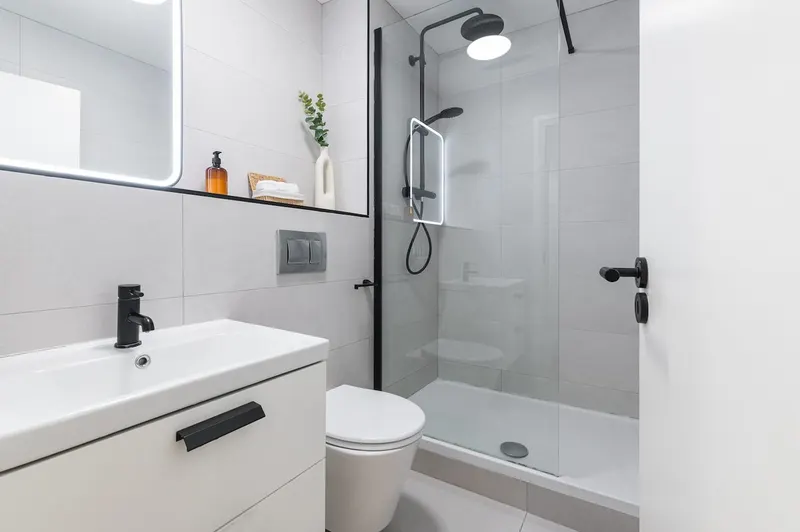 Modern walk-in shower room with rainfall head, vanity unit and WC in EirStay Islandbridge serviced apartment Dublin 8