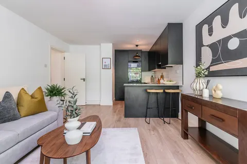 Open-plan living and kitchen with sofa, breakfast bar and console table in EirStay Islandbridge serviced apartment Dublin 8