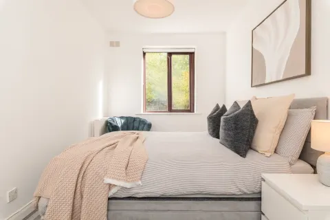 Side view of the double bed and window in the Rathgar apartment