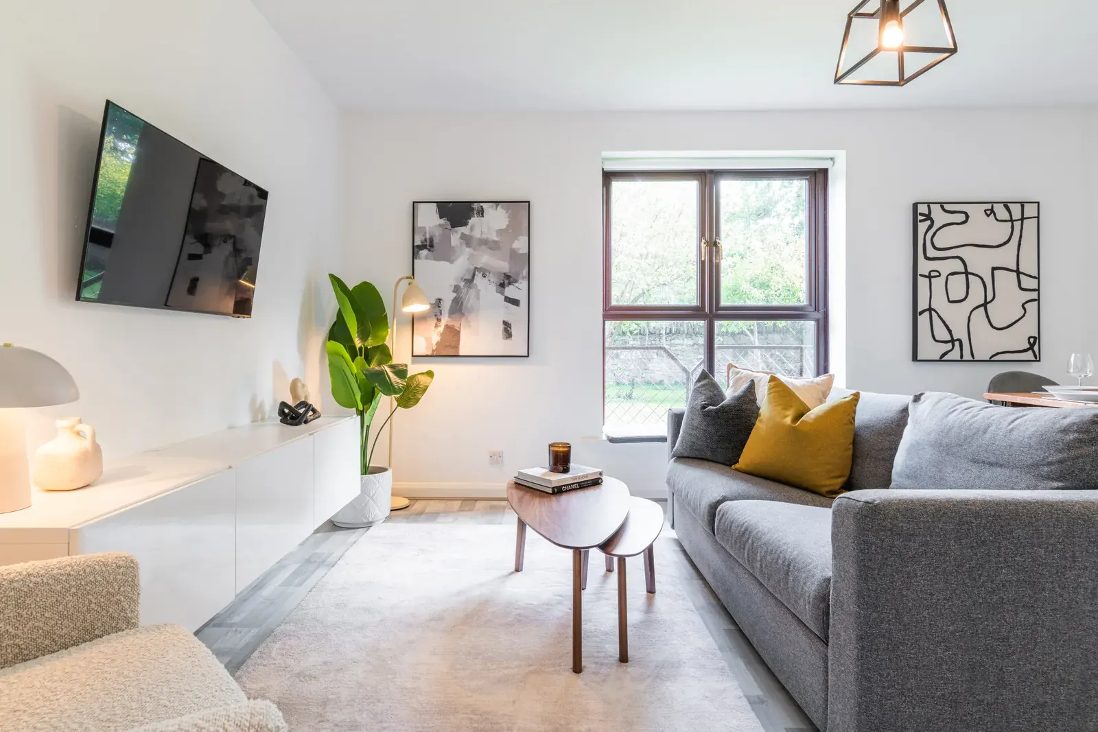 Rathgar apartment living room with grey sofa, coffee table and large window