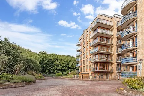 Modern apartment building exterior with curved balconies and landscaped grounds in EirStay serviced apartment complex Kilmainham Dublin 8