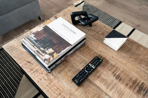 Rustic wood coffee table with This Is Home book and black chain sculpture in EirStay serviced apartment Kilmainham Dublin 8