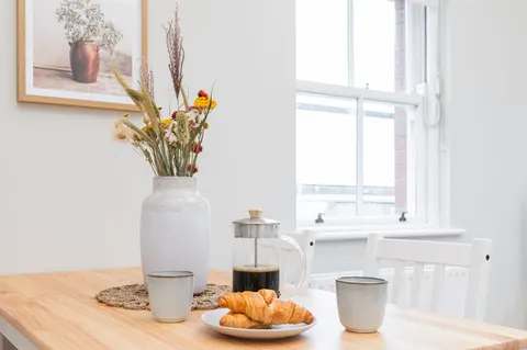 Breakfast dining table with French press coffee and croissants in EirStay serviced apartment Morehampton Road Dublin 4