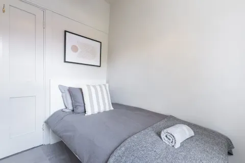 Third bedroom with a single bed, bedside table and wardrobe at Sandford Gardens