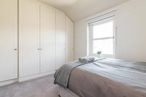 Built-in wardrobes and a double bed in the second bedroom at Sandford Gardens